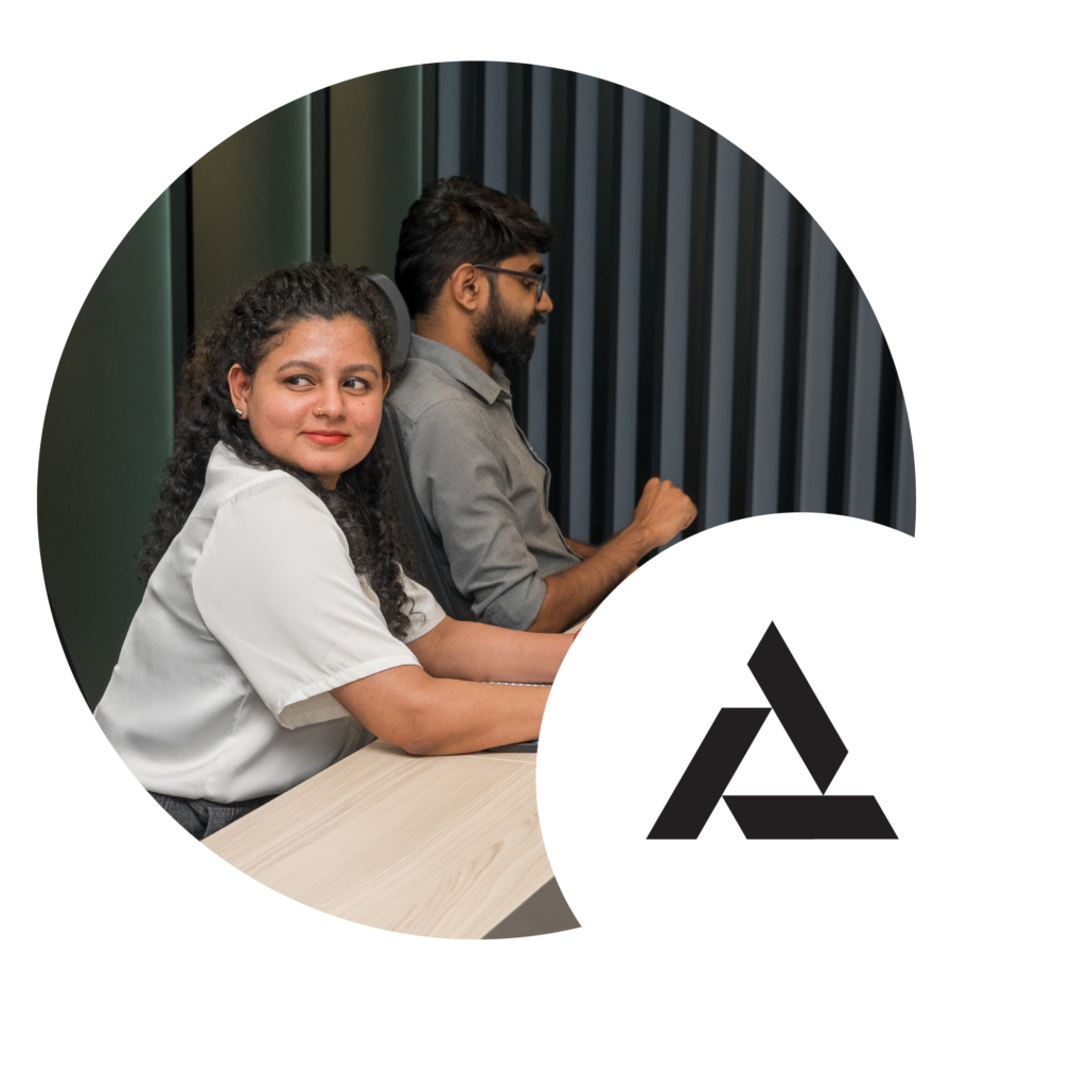 female team member leaning on desk